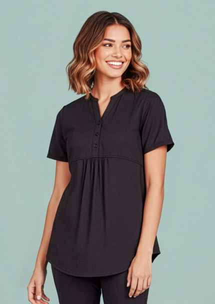 A women's black tunic scrub top featuring a buttoned neckline and a relaxed fit. The top has a logo on it.