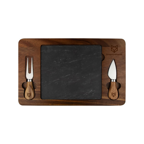 A slate cheeseboard with a wooden border and two cheese knives, featuring a logo. The board has a rectangular shape.