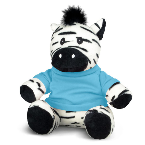 A black and white striped zebra plush toy wearing a blue shirt, with a tuft of black fur on its head.
