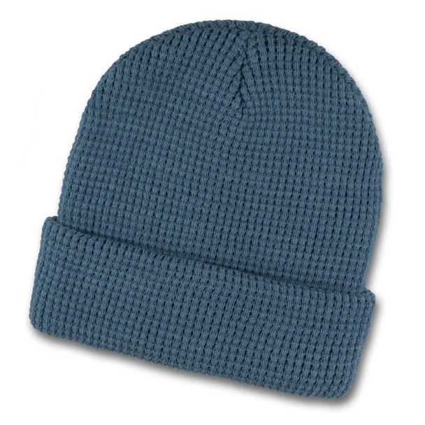 A blue waffle beanie featuring a ribbed texture and a folded cuff, with a logo on the side.