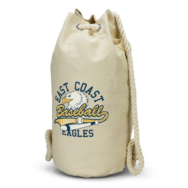 A cream-coloured canvas barrel bag with a rope handle and a logo featuring an eagle and text.
