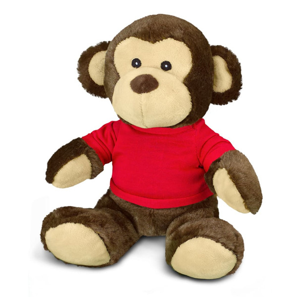 A plush monkey toy featuring brown fur and a red shirt, sitting with a friendly expression. It has a branding logo.