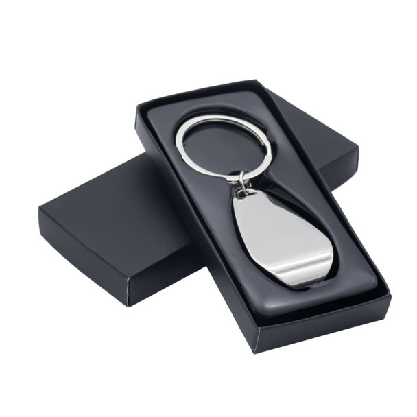 A metallic silver keychain displayed inside a sleek black box with a lid. The box has a smooth finish.