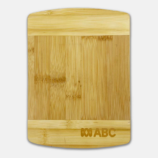 A bamboo cutting board featuring a smooth surface with a rectangular shape and a small logo on one side.