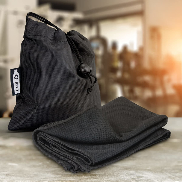A black RPET cooling towel neatly folded next to a matching drawstring bag, featuring a logo. A black RPET cooling towel neatly folded next to a matching drawstring bag, featuring a logo.
