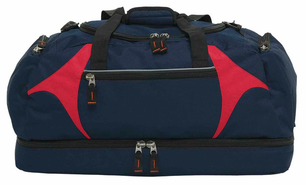 A navy blue duffle bag with red accents, featuring multiple zippered compartments and sturdy black handles.