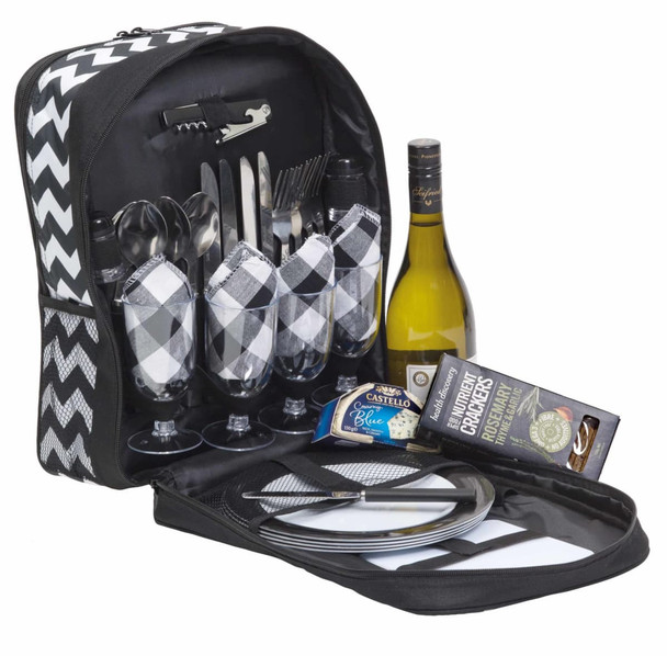 A picnic set featuring a black and white chevron bag, wine bottle, glassware, cutlery, and dinner plates.