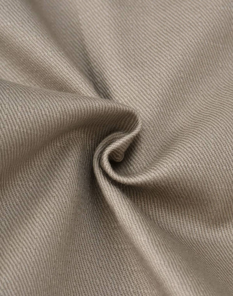 A close-up of beige cotton stretch ripstop fabric, showcasing its smooth texture and woven pattern.