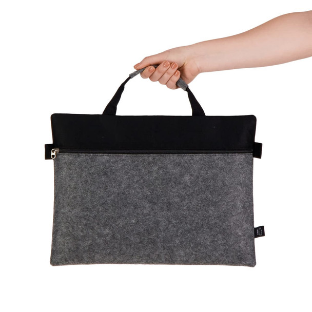 A grey felt satchel with a black top, featuring a zippered closure and dual handles.