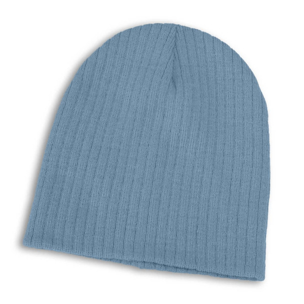 A Nebraska Cable Knit Beanie in a soft blue hue, featuring a ribbed texture for warmth and comfort.