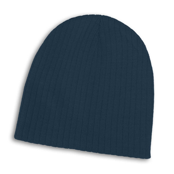A navy blue cable knit beanie featuring a ribbed texture and a logo on the side.