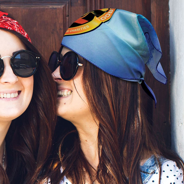 A triangle bandana in blue with a logo, worn by two women. One woman is also wearing a red bandana. A triangle bandana in blue with a logo, worn by two women. One woman is also wearing a red bandana.
