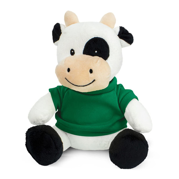 A plush cow toy with a white and black design, wearing a green shirt, seated with a smiling expression.