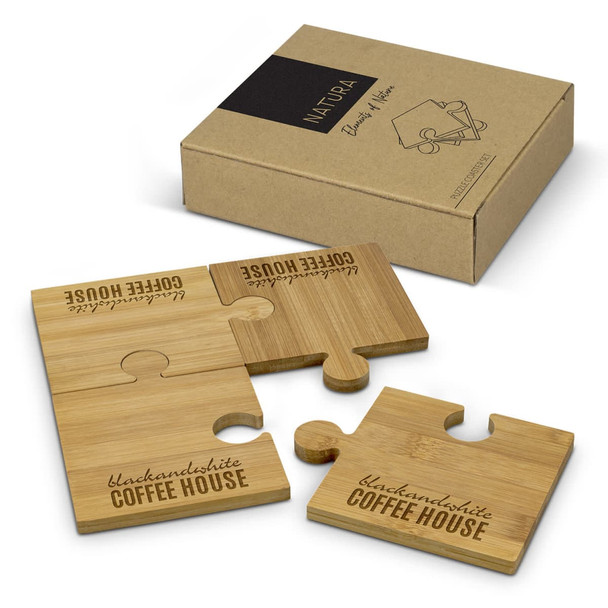 A natural bamboo coaster set featuring four interlocking puzzle pieces, presented in a cardboard box with a logo.