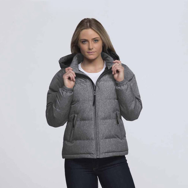 A woman wearing a grey puffer jacket with a hood, featuring a front zipper and side pockets. A woman wearing a grey puffer jacket with a hood, featuring a front zipper and side pockets.