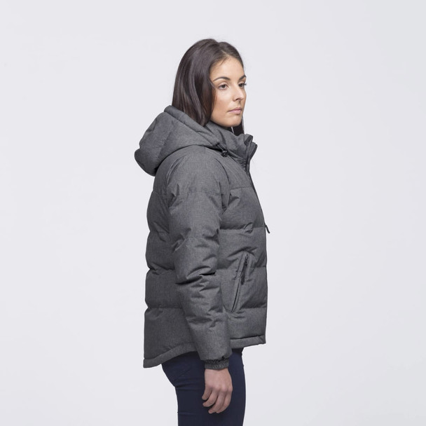 A grey puffer jacket with a hood, featuring a side view of a person wearing it. The jacket has a logo. A grey puffer jacket with a hood, featuring a side view of a person wearing it. The jacket has a logo.