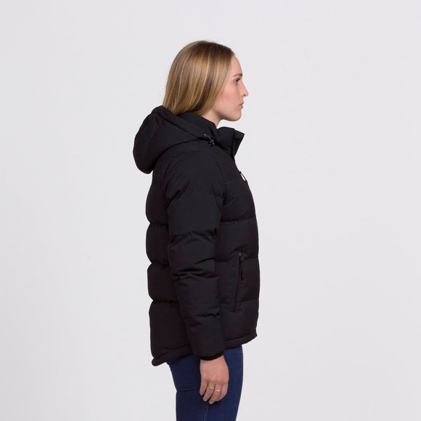 A side view of a black puffer jacket featuring a hood and zippered pockets. The model stands in profile.