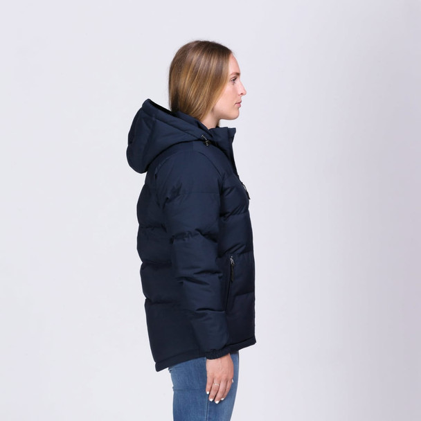A navy puffer jacket with a hood, featuring a zip and pockets, displayed on a model from the side. A navy puffer jacket with a hood, featuring a zip and pockets, displayed on a model from the side.