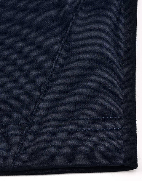 A close-up of the navy fabric of a polo shirt showcasing textured stitching details.