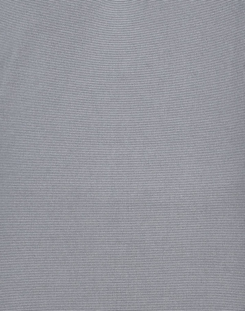 A light blue polo shirt featuring a textured pattern and a logo.