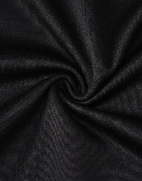 A close-up of black fabric with a smooth texture, showcasing the sustainable poly/cotton blend.