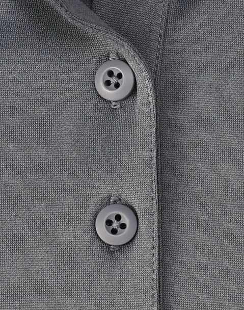 A grey polo shirt featuring two grey buttons on the collar, made from sustainable poly/cotton fabric. A grey polo shirt featuring two grey buttons on the collar, made from sustainable poly/cotton fabric.