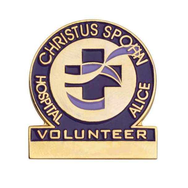 A gold and blue enamel lapel pin with a cross design and the word "VOLUNTEER" at the base.