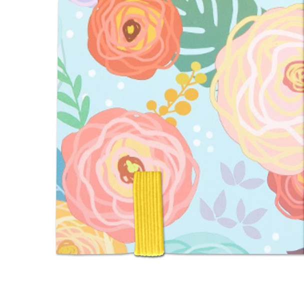 A notebook with a full-colour floral cardboard cover in pastel shades, featuring a yellow elastic band.