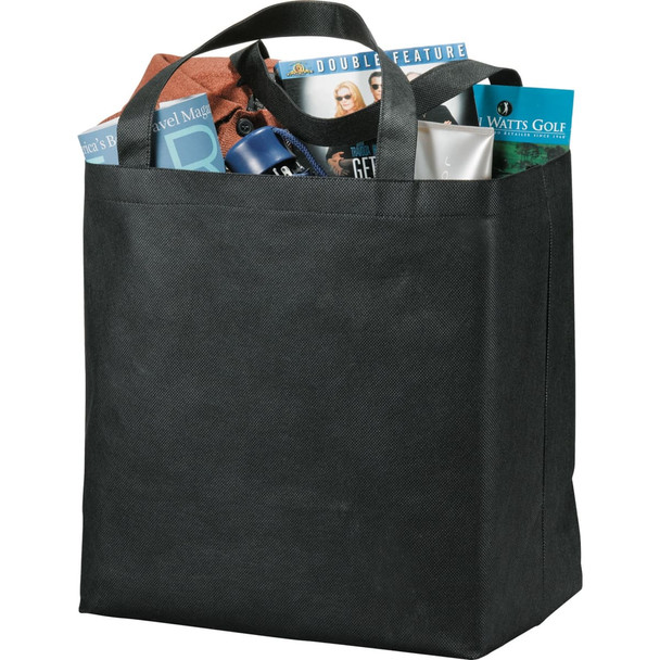 A black non-woven tote bag filled with various items including magazines, a drink bottle, and personal care products.