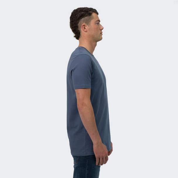 A male model stands in profile wearing a blue TRENDSWEAR Original men's T-shirt. The shirt features a logo.