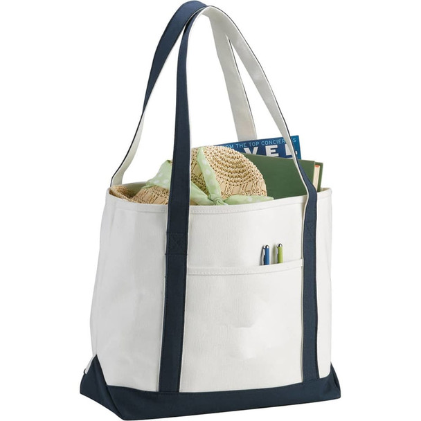 A heavy weight cotton boat tote in cream with navy accents, featuring side pockets and sturdy straps.