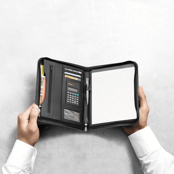 A black portfolio opened to reveal a notepad, calculator, pen, and card slots, held in hands.