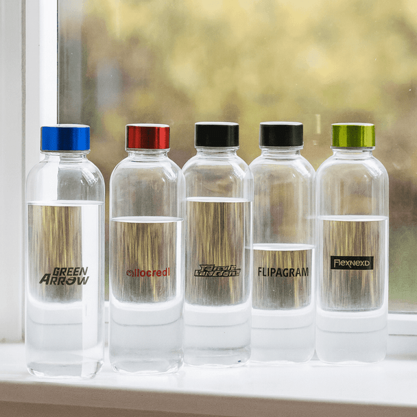 A drink bottle collection featuring five clear Tritan bottles with coloured caps in blue, red, black, and green.