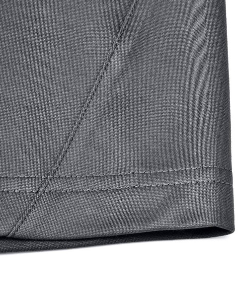 A close-up of the hem and fabric of a grey men's sustainable polo shirt, featuring a stitched edge. A close-up of the hem and fabric of a grey men's sustainable polo shirt, featuring a stitched edge.