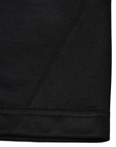 A close-up view of the hem of a black polo shirt, featuring subtle stitching details and a logo. A close-up view of the hem of a black polo shirt, featuring subtle stitching details and a logo.