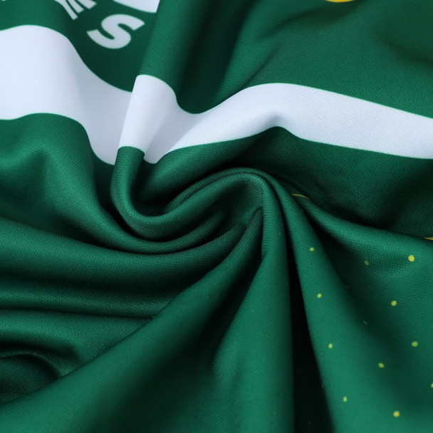 A close-up of green polyester fabric, featuring a smooth texture and subtle patterns, with a logo.