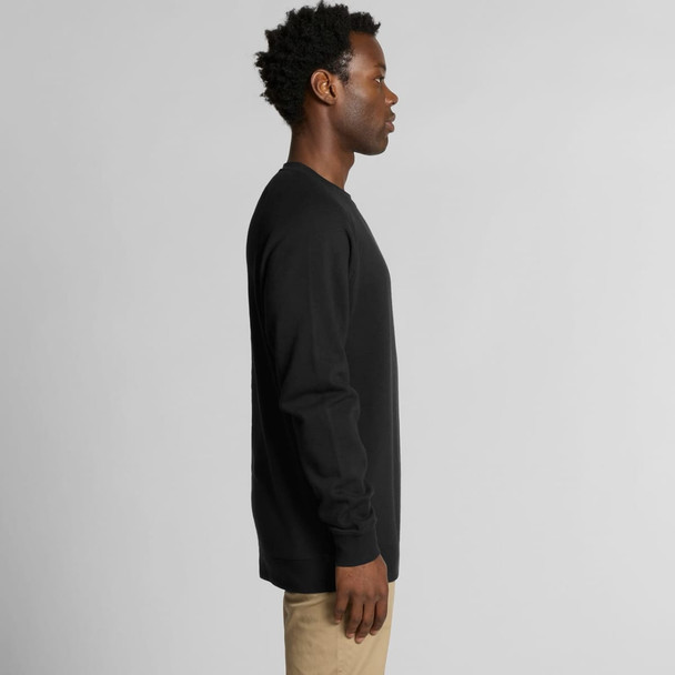 A black jumper with long sleeves, featuring a side view of a person wearing it. The product includes a logo. A black jumper with long sleeves, featuring a side view of a person wearing it. The product includes a logo.