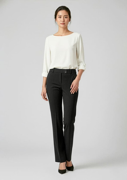 A model wearing black slacks paired with a white blouse, standing against a neutral background. The pants have a sleek design and a logo.
