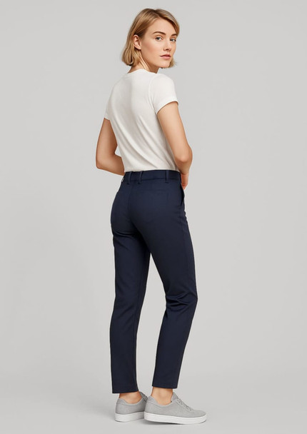 A pair of women's slim leg stretch chino pants in navy, styled with a fitted white t-shirt and grey shoes. A pair of women's slim leg stretch chino pants in navy, styled with a fitted white t-shirt and grey shoes.