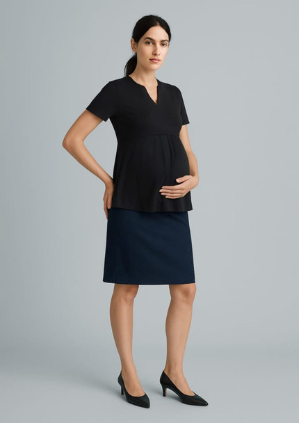 A maternity skirt in navy blue, paired with a black top, displayed on a model. The model is holding her belly. A maternity skirt in navy blue, paired with a black top, displayed on a model. The model is holding her belly.