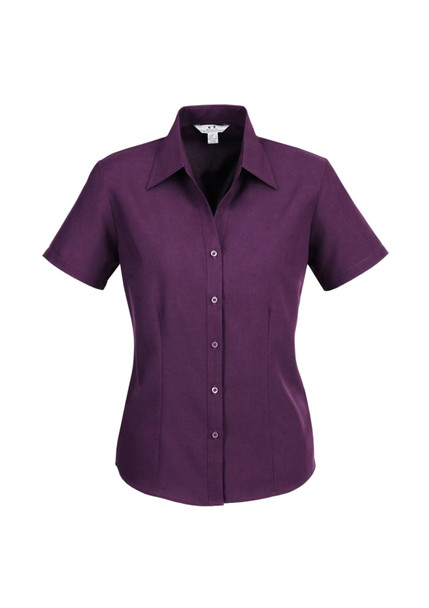 A short sleeve button-up shirt in a deep purple colour, featuring a collar and front buttons. It has a logo.