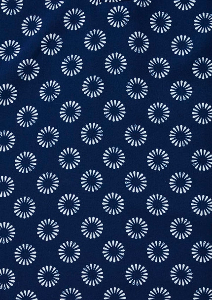 A navy tunic featuring a daisy print pattern in white. Includes a logo.