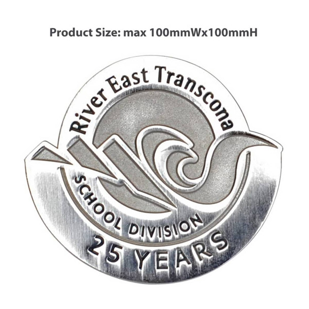 A silver die struck lapel pin featuring a wave design and text indicating "25 Years". It includes a logo and is circular.