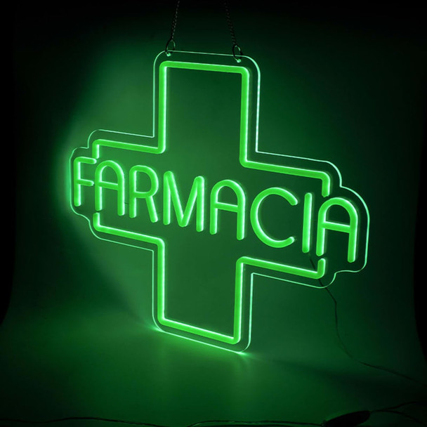 A green neon LED sign featuring a cross shape and the word "FARMACIA." It has a hanging chain and a glowing effect.