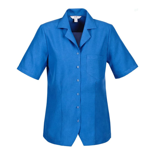 A short-sleeved blue overblouse with a collar and a single chest pocket, featuring buttons down the front and a logo.