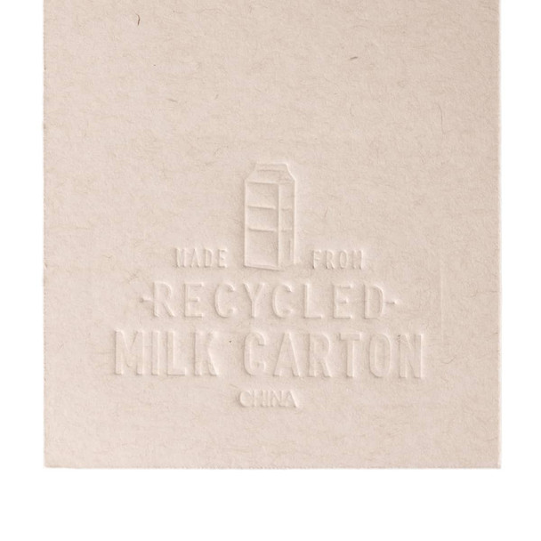 A booklet made from recycled milk cartons, featuring an embossed design that highlights its eco-friendly material.