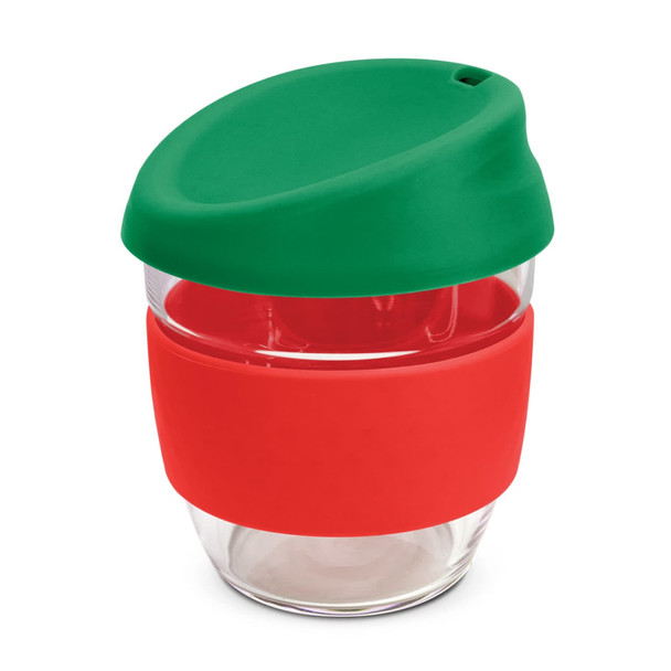 A drink bottle made of clear borosilicate glass with a green silicone lid and a red silicone band.