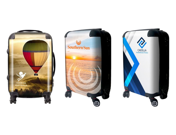 Three wheeled carry-on suitcases featuring colourful designs, including a hot air balloon, sunset, and abstract patterns.