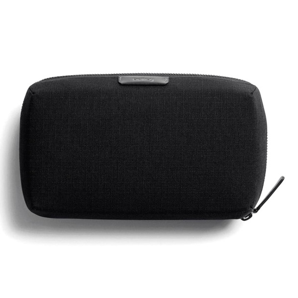 A black tech kit bag with a textured surface and a zip closure, featuring a branding logo. A black tech kit bag with a textured surface and a zip closure, featuring a branding logo.