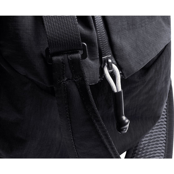 A black duffel bag featuring a zip closure, adjustable strap, and a branded logo on the material.